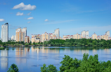 Fototapeta na wymiar View at residential district Obolon on the bank of Dnieper river at sunny summer day. Kyiv, Ukraine.