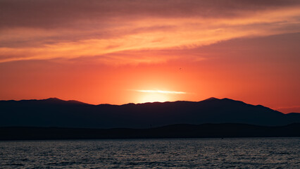 Colorful sunset over a coastal mountain range..