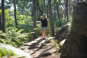 Naklejka premium caucasian woman hiking in french forest