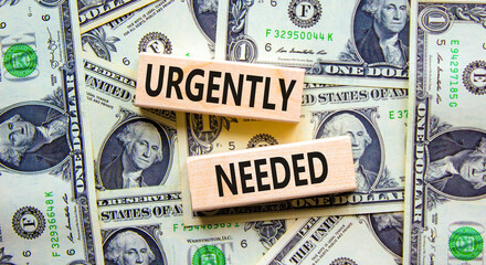Urgently needed symbol. Concept words Urgently needed on wooden blocks on a beautiful background...
