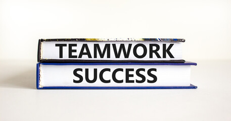 Teamwork success symbol. Concept words Teamwork success on books on a beautiful white table white background. Business and teamwork success concept. Copy space.