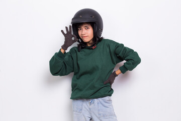 beautiful asian woman with a motorcycle helmet showing a thumbs up ok gesture on white background
