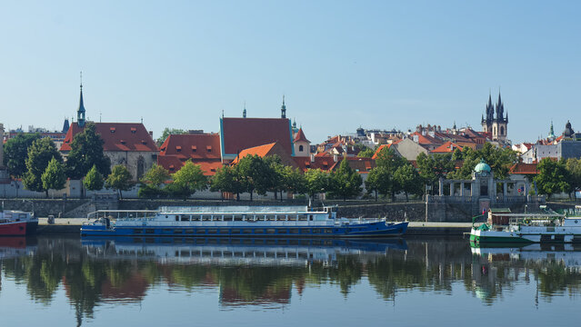 Na Františku, district of Old Town of Prague with cruise ships docked in foreground and buildings of the St. Agnes Convent. The towers of Church of Our Lady in front of Tyn stand out in background.