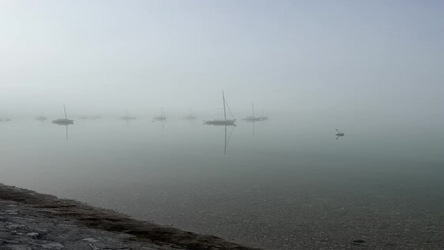 Vertical shot of the ships in Achen Lake from the shore on gloomy day