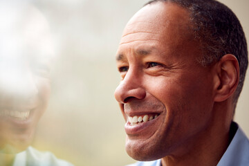 Obraz premium Head And Shoulders Portrait Of Mature Man Or Businessman Standing By Window In Office Or At Home