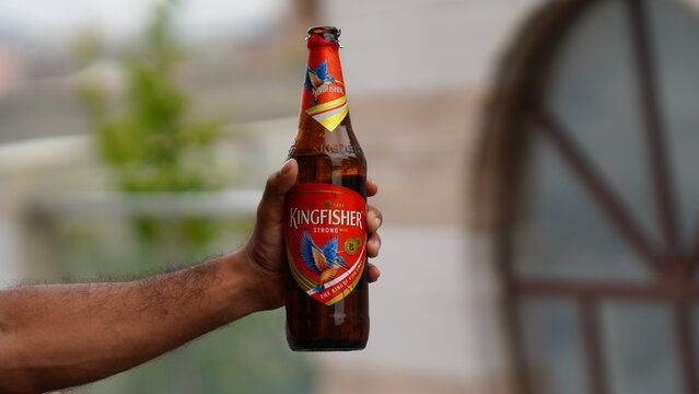 Sitamarhi, Bihar, India- 14 ‎June ‎2022 :showing up a beer bottle holding in hand