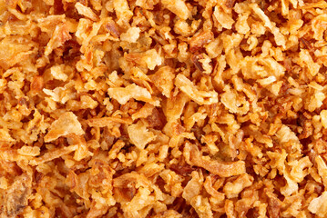 Roasted onions background. Crispy fried onions. Top view.