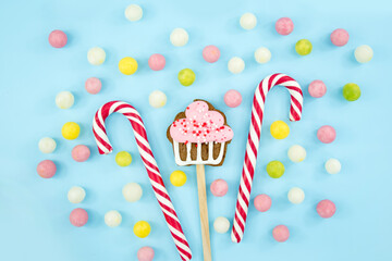 sweets, candies, cookies and lollipops on a blue background. Sweet Christmas Canes Top view copy...