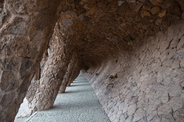 Stone columns creating tunnel in Park Guell in Barcelona, Spain