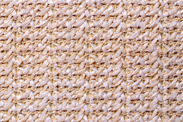 Polyester background texture. Close-up of colorful beige white synthetic fiber pattern for textile, bags  or other garments. Macro.