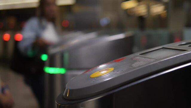 Subway turnstile. A person passes through the turnstile using an electronic touch card. Entrance fee