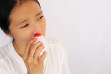 A woman with a nosebleed uses toilet paper to stop it from bleeding any more. the idea of health...