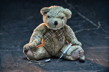 The Teddy bear symbolizing a child. Teddy bear are drug addict. Concept of children's drug addiction