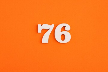 Number 76 - On orange foam rubber background