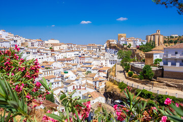 Setenil de las Bodegas. Typical andalucian village with white houses and sreets with dwellings built into rock overhangs above Rio Trejo. Andalusia. Spain - 521276750