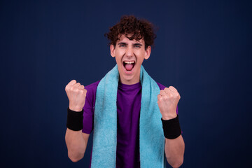 Fitness and healthy lifestyle. Athletic funny guy. Blue background.	
