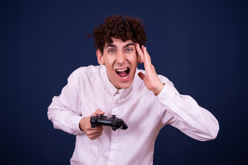 Funny young guy plays a video game.	