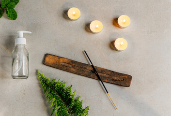 lotion bottle with incense and candles and mint
