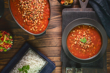 Arabic Cuisine; Middle Eastern traditional black- eyed beans in tomato sauce. Served with white rice and oriental pickles and green salad.