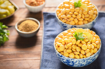 Fototapeta na wymiar Arabic Cuisine; Middle Eastern traditional snack Lupin beans or Termes. It's very healthy beans that can be served as snack or antipasti. Close up with copy space.