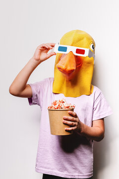 Faceless kid in duck mask and 3D glasses