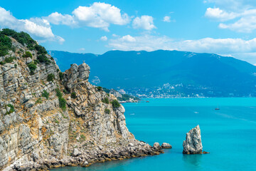 Fototapeta premium Sail Rock near the sea or ocean and blue sky with clouds, Yalta, Crimea, Swallow's Nest.