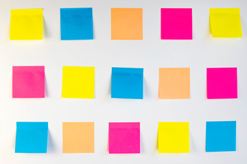 many colorful sticky notes on a white background. Place for text.