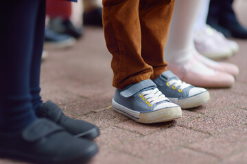 School children's feet wearing comfortable shoes. Kids boots. Parent's care before school year. Back to school