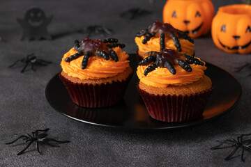 Homemade Halloween cupcakes with decorated spiders. Sweets for kids on Halloween