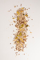 Mix of seeds for a salad. A pile of mixed seeds isolated on white background.