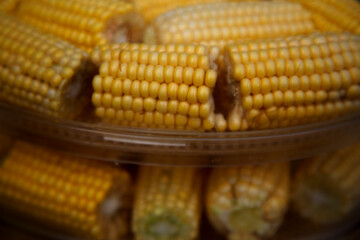 Heads of corn laid out for cooking in a double boiler. Corn broken into pieces in a steamer. The concept of food, vegetarianism, healthy food.