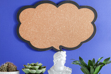 gypsum statue and plants with blank sign on blue background. copy space, advertisement, presentation. New ideas, creativity and think out of the box