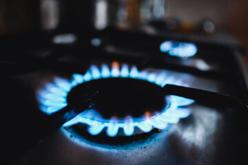 Gas stove, gas flame. Gas in the kitchen. Natural gas shortage. Defocused