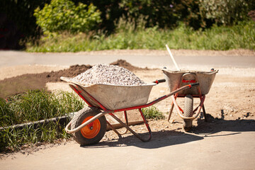 Wheelbarrow with gravel at the construction site