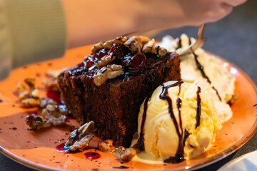 Piece of brownie chocolate cake with vanilla ice cream