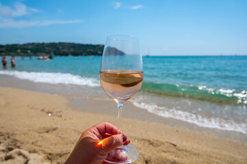 Cold rose wine from Provence served outdoor on white sandy beach Plage de Pampelonne near Saint-Tropez, France