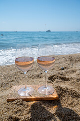 Cold rose wine from Provence served outdoor on white sandy beach Plage de Pampelonne near Saint-Tropez, France
