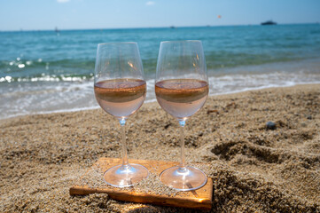 Cold rose wine from Provence served outdoor on white sandy beach Plage de Pampelonne near Saint-Tropez, France