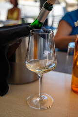 Drinking of txakoli or chacolí slightly sparkling very dry white wine produced in Spanish Basque Country, served in restaurant in Getaria, Spain