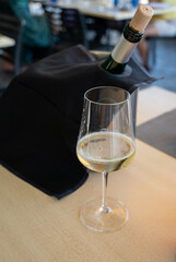 Drinking of txakoli or chacolí slightly sparkling very dry white wine produced in Spanish Basque Country, served in restaurant in Getaria, Spain