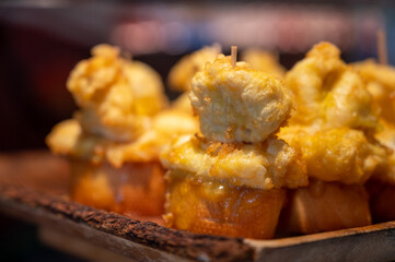 Typical snack is bars of Basque Country pinchos or pinxtos, small slices of bread upon which ingredient or mixture of ingredients is placed and fastened with toothpick, San Sebastian, Spain