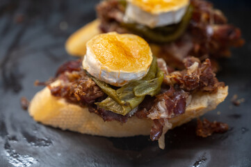 Typical snack of Basque Country and Navarre, pinchos or pinxtos served in bar, small slices of bread upon which ingredient or mixture of ingredients is placed, San Sebastian, Spain