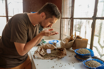 Side view of professional male Q-Grader checking the quality of coffee in production in Africa