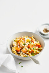 Italian pasta Mafalda Corta trafilata al bronzo with sauteed sweet potato, fennel, parmesan grated cheese on white background. Vegetarian meatless food.