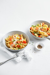 Italian pasta Mafalda Corta trafilata al bronzo with sauteed sweet potato, fennel, parmesan grated cheese on white background. Vegetarian meatless food. No people.