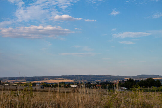 Panorama of a small German village Calden against a blue sky with clouds