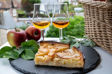 Tasting of baked apple cake and strong alcoholic drink calvados made from apples in Normandy, Calvados region, France
