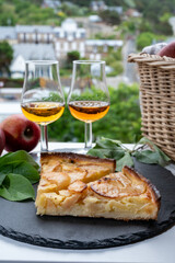 Tasting of baked apple cake and strong alcoholic drink calvados made from apples in Normandy, Calvados region, France