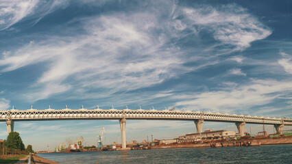 Dramatic industrial landscape with elevated highway, sea port and cloudy sky