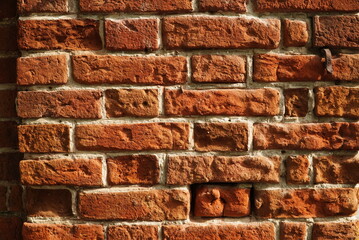 Fragment of a ceramic brick wall with white masonry mortar, white masonry seams, close-up